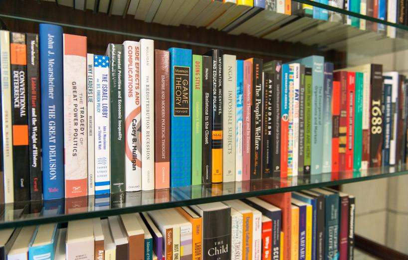 faculty books displayed on a bookshelf