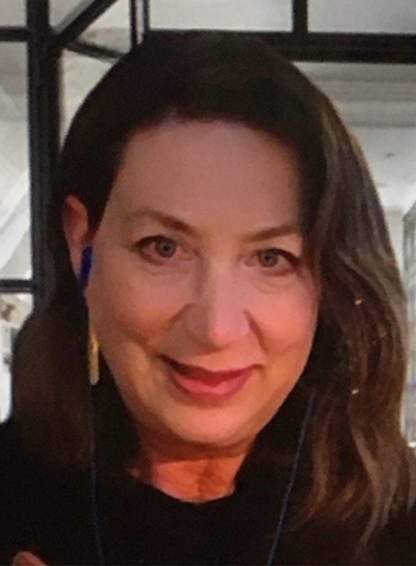 Woman with long brown hair and dark shirt.