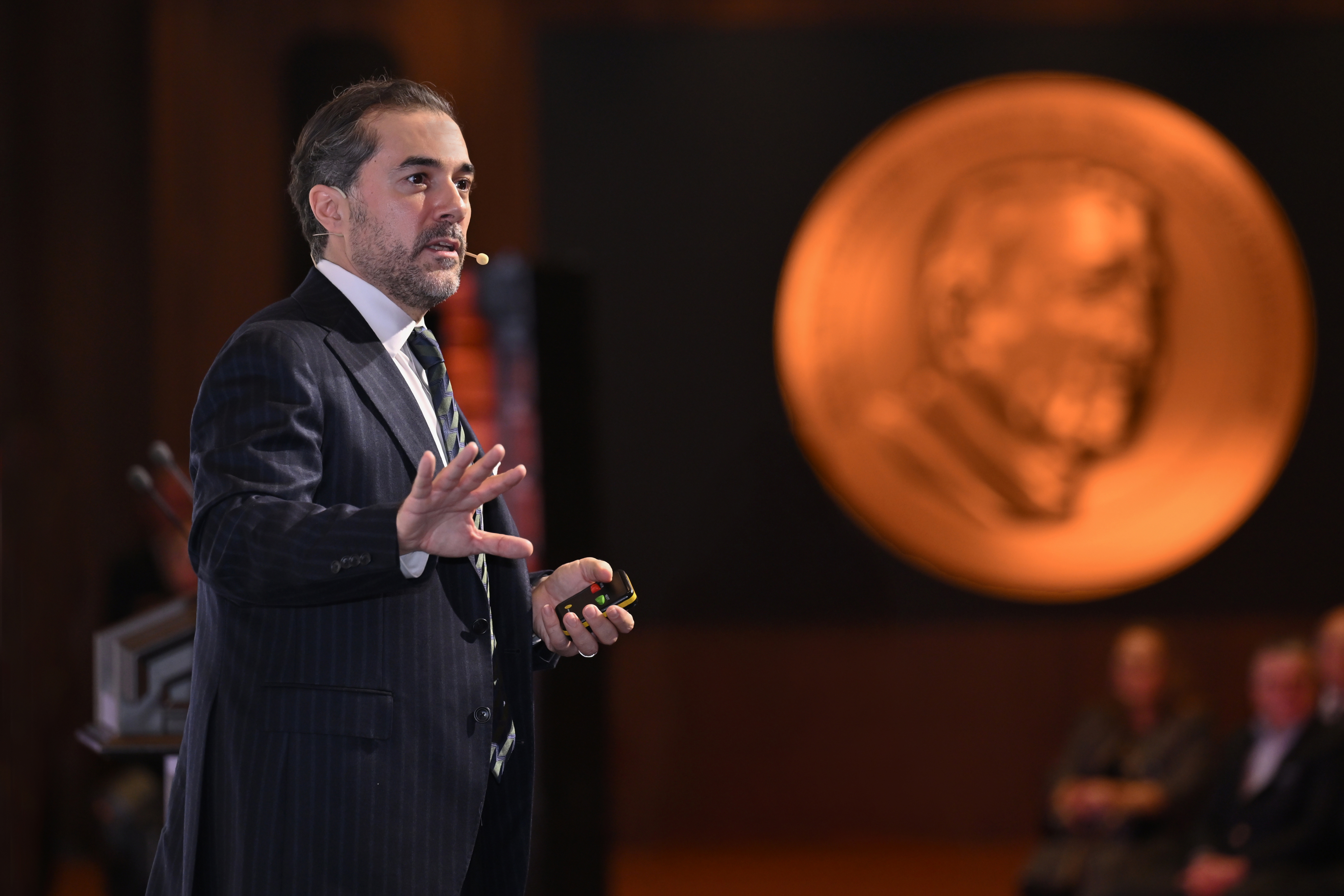 Photo of Ufuk Akcigit presenting at the 2025 award ceremony. Photo courtesy of of Koç University.