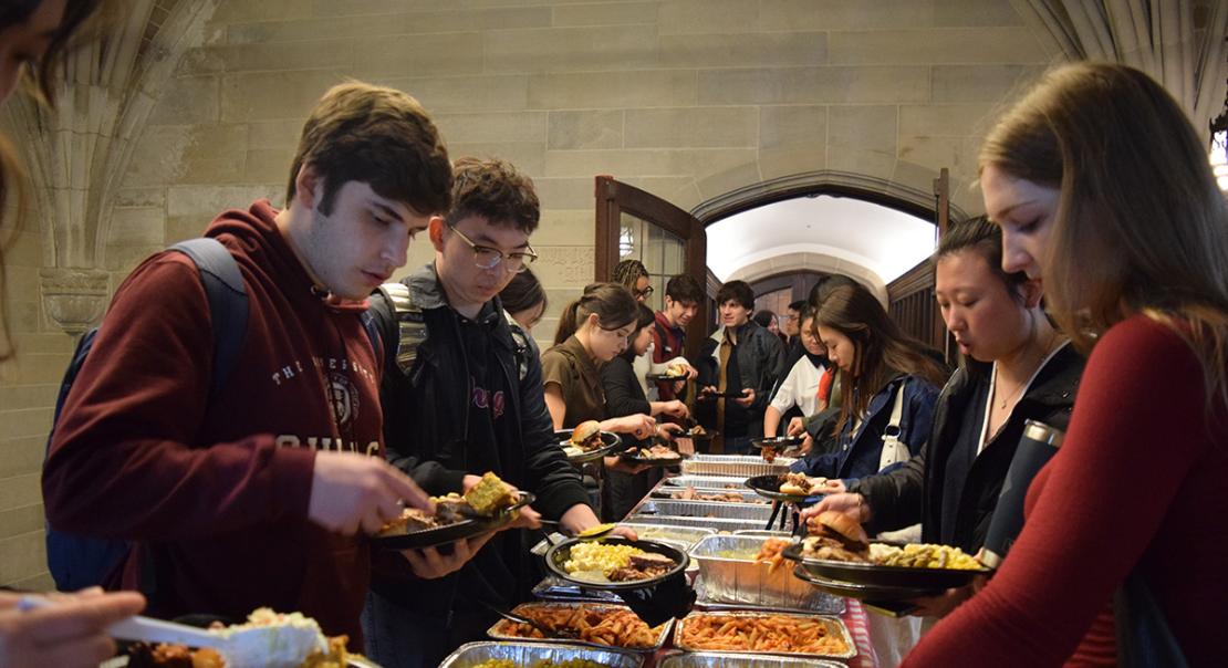 Third and fourth year economics majors load their plates at the annual Undergraduate BBQ