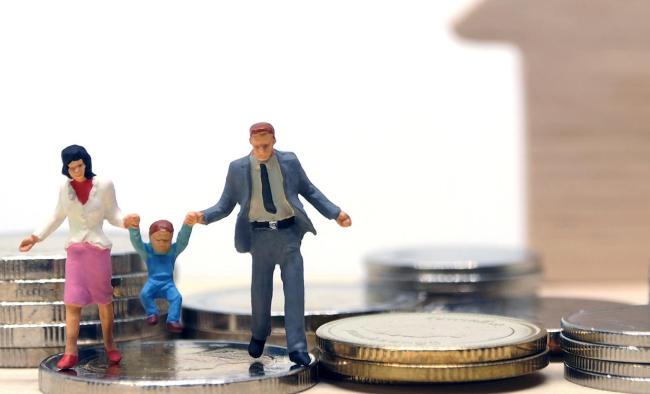 miniature figurines depicting a family walking on coins