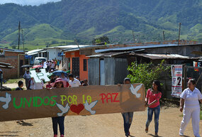 Community members of La Ciudadela in Florencia, Caquetá, Colombia organize a march to support peacebuilding efforts in the Fall of 2015.