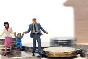 miniature figurines depicting a family walking on coins