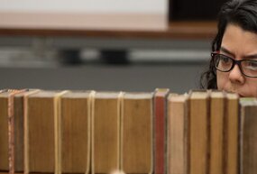 Student browsing library shelves